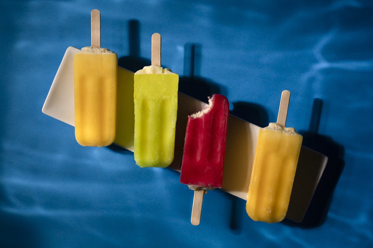 Bulla Ice creams on whit dish with pool and water light effect as background