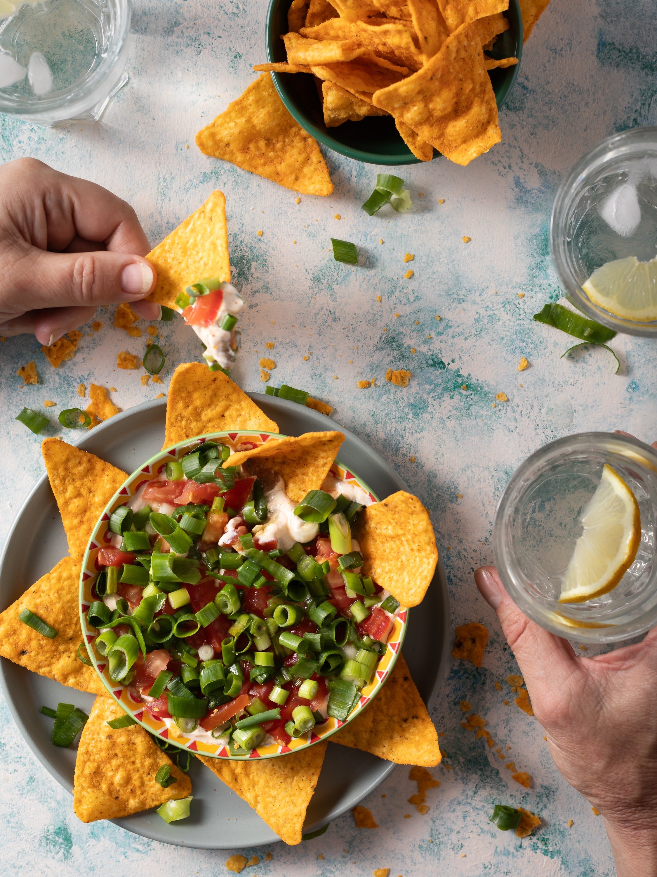 Mexican styled dip with corn chips and iced lemon water photographed by Steve Wickenton food photographer