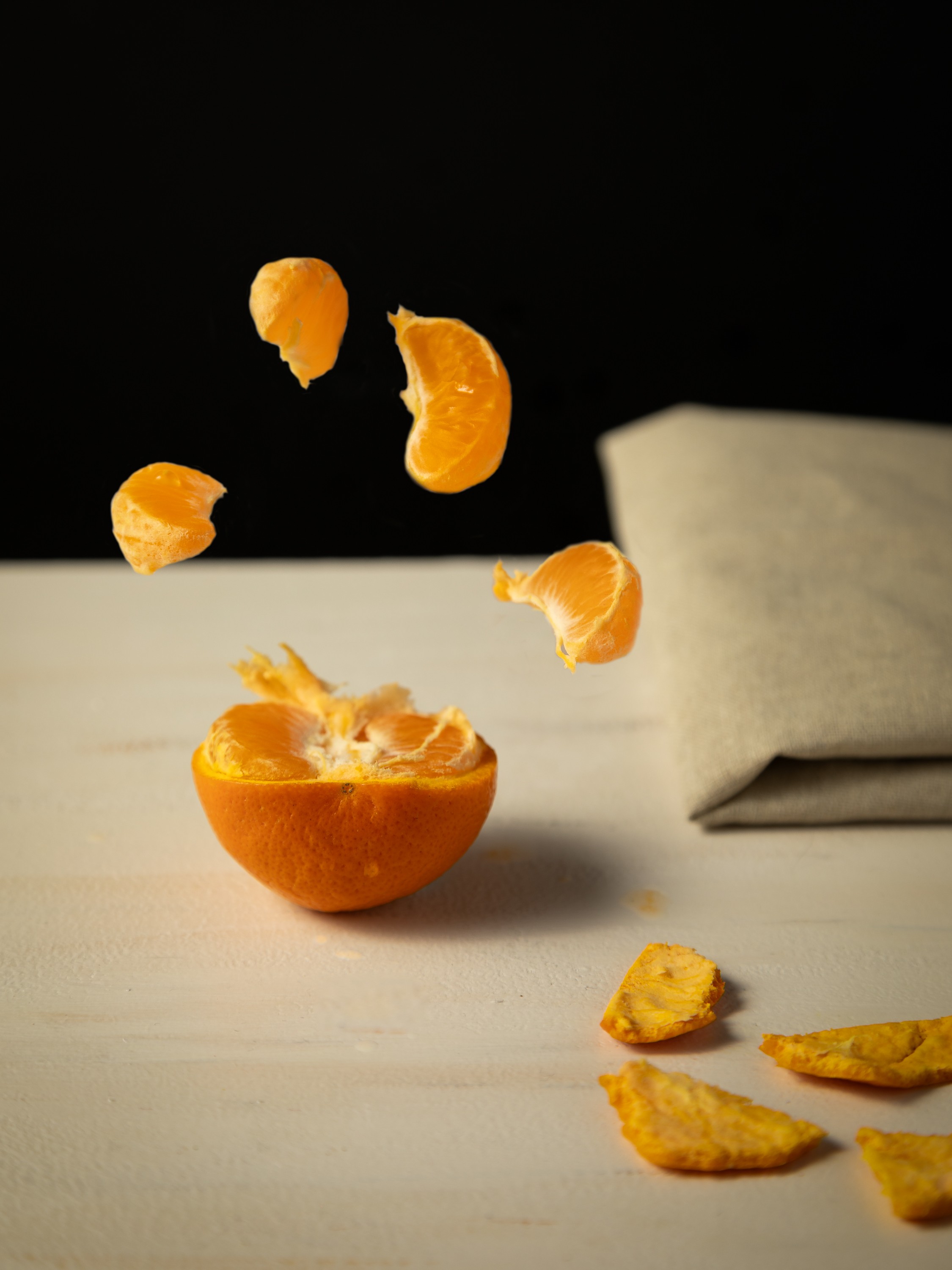 Fresh produce photograph of Mandarin popping with flavour in fly about action shot.
